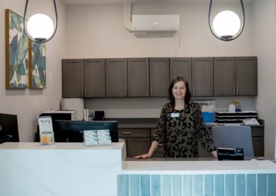 A member of Prime Carolina Coast's friendly team waits to provide service at the front desk.