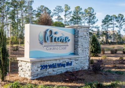 A stacked rock sign displaying Prime Carolina Coast's logo