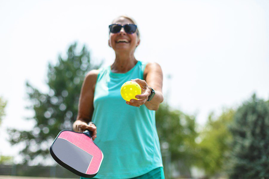 Mature-Adult-Female-Playing-Pickle-Ball-Photo-Series-1334370324_sm