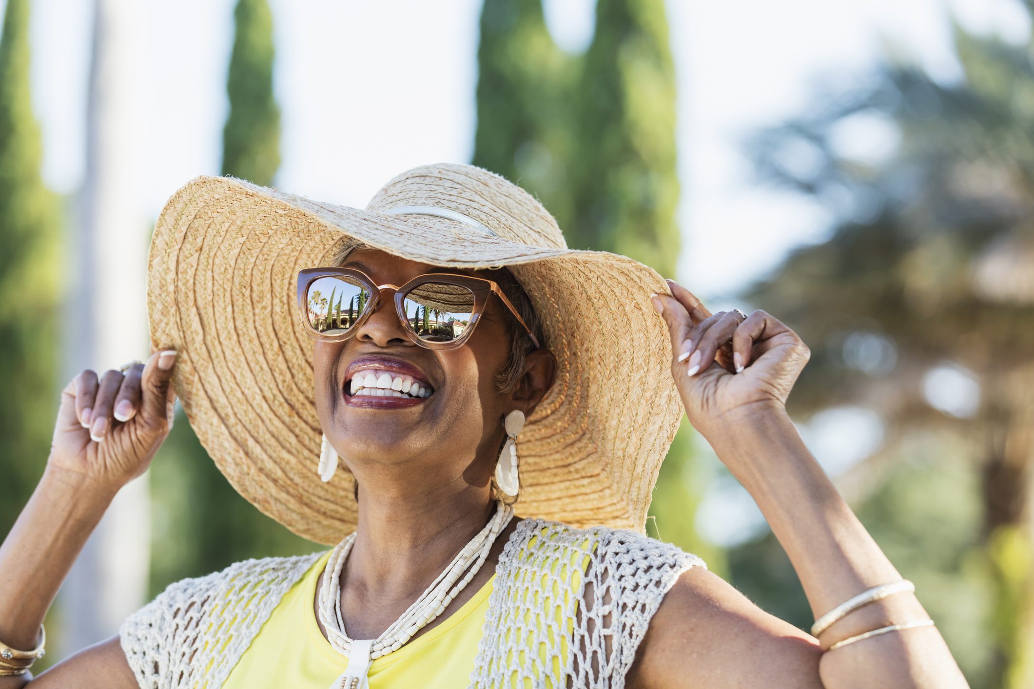 Senior African-American woman wearing sunglasses Smiling older woman in hat and sunglasses