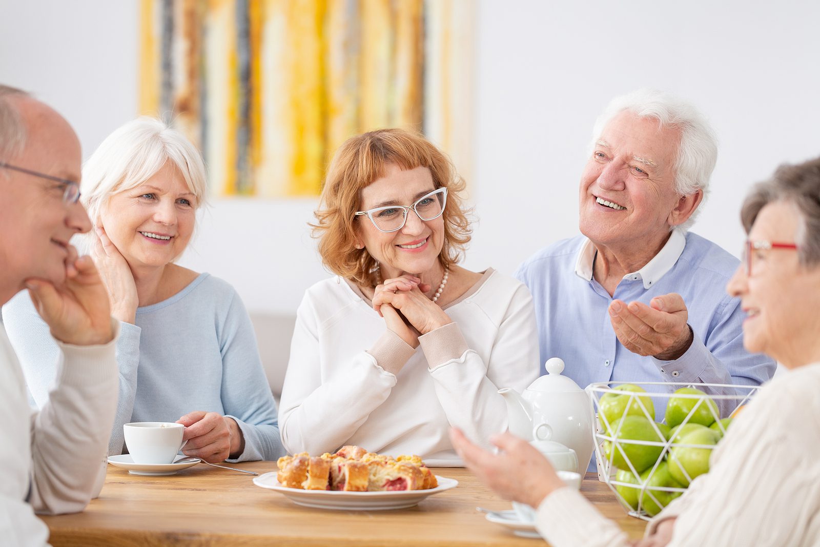 Group of older adults eating meal together